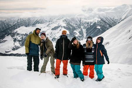 Group of travellers posing on mountain topの写真素材