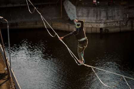 one sportsman walk and balanced on stretched sling.の写真素材