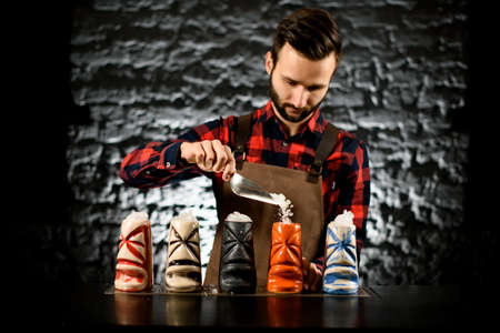 bartender pouring pieces of ice into ceramic glass.の写真素材
