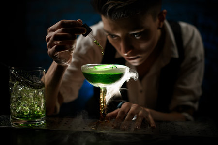 Woman bartender carefully add component to smoky glass with green cocktail.