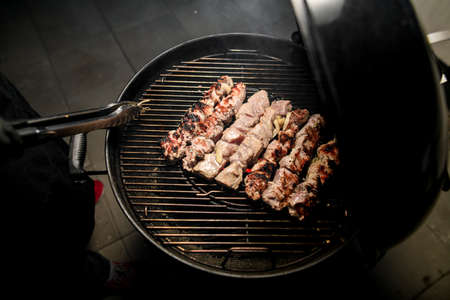 Top view of barbecue on which pieces of beef meat are fried.の写真素材