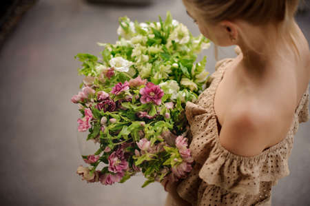 Top view of girl who holds bouquet in her hand.の写真素材
