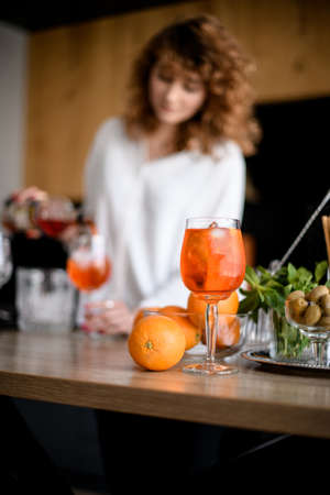 beautiful glass of cold bright orange drink stand on the tableの写真素材