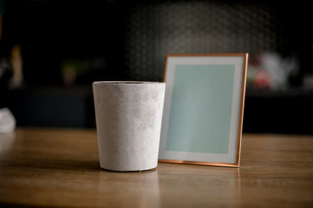 photo frame and glass with candle stand on table.の写真素材
