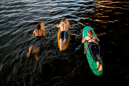 Top view of group of people which floating on surf boards on river waterの写真素材