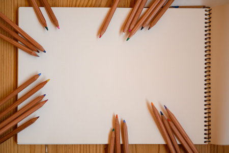 close-up of white sheet of paper with colored pencils around it