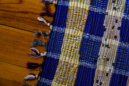 Homemade woven rug on the wooden surface of the floor