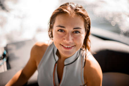 Portrait of happy woman with brown wet hair on blurred backgroundの写真素材