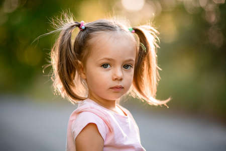 Portrait of cute little girl with blue eyes and blond hairの写真素材