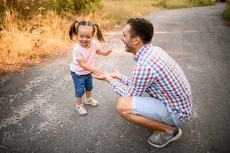 Young father plays with his daughter in the park
