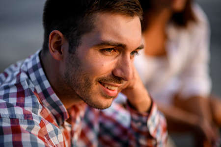 Close-up view on young beautiful dark haired man in shirtの写真素材