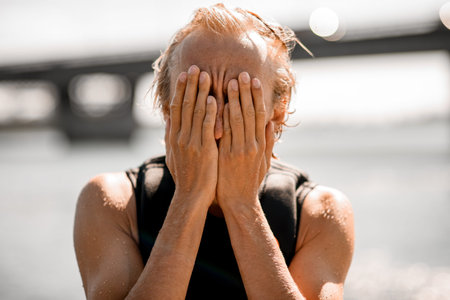 portrait of man who covered his face with his hands