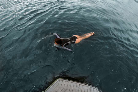 High angle view of woman who active floating on the waterの写真素材