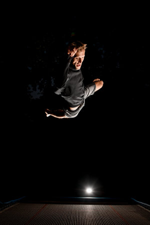 Man having fun and jump high on trampoline