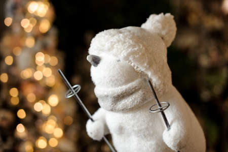 Close-up of cute figurine of white toy penguin with ski polesの写真素材
