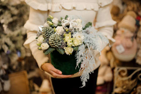 beautiful New Years composition in round green box in hands of woman.の写真素材