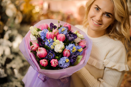 charming bouquet of colorful spring fresh flowers h in hands of blonde woman.