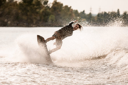screaming man rides on wakeboard and falling into the splashing water