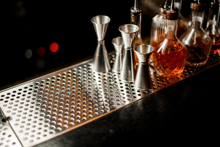 great view of bar on which stands several jiggers and bottles of drinksの写真素材