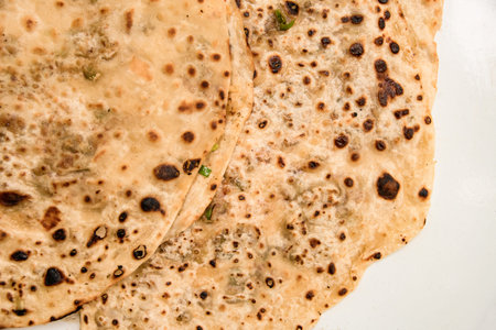 horizontal view from above of freshly fried pita bread or flatbread.