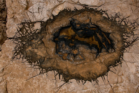 texture of old stone with incredible pattern of cracks on the surface.