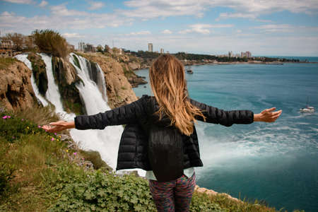 rear view of attractive woman on background of Duden waterfall in Antalya,Turkey.の写真素材