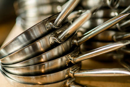 close-up of clean pans on top of each other. Kitchen equipment and utensilの写真素材