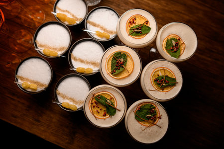 top view of group ofglasses with tasty foamy drink on wooden tableの写真素材