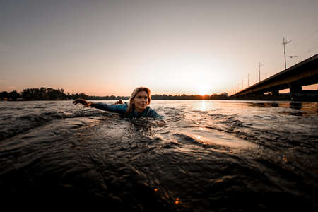 great view of beautiful face of attractive young woman floating on waterの写真素材