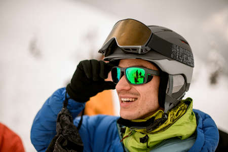 close-up of head of male skier in helmet with goggles on his faceの写真素材