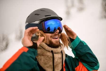 Head shot of joyful man skier wearing ski helmet and gogglesの写真素材