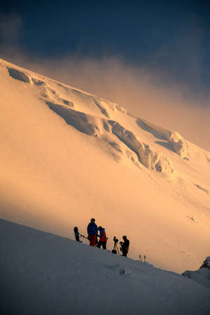 wonderful view of the mountain slope and a group of tourists on itの写真素材
