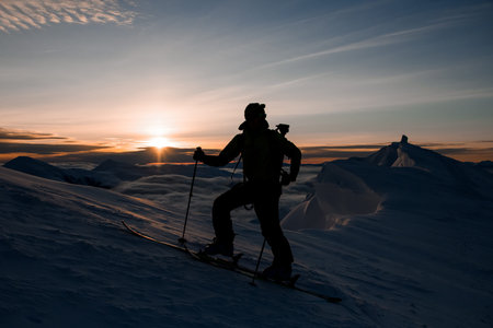 silhouette of a skier against the backdrop of the beautiful sky and sunrise