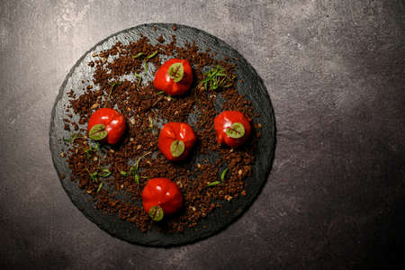 plate of molecular garlic covered with red jelly on ground meatの写真素材