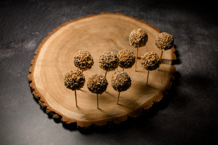 Tasty chocolate cake pops with nut and golden flakes