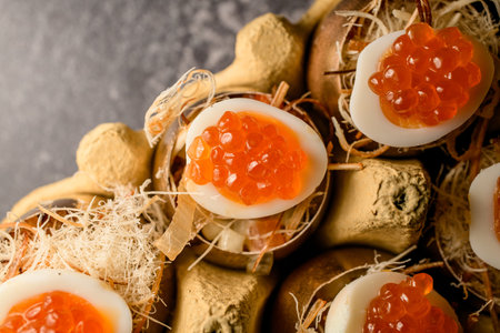 eggs stuffed with red caviar serving in golden shell