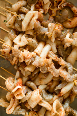 Close-up top view of the raw seafood kebab