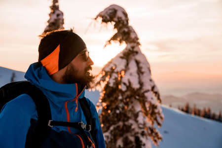 portrait of a male skier on the background of a winter landscapeの写真素材