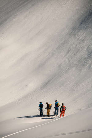 Great view of group of people skiers at snow powdered mountain slopeの写真素材