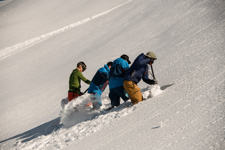 men are digging snow and checking the mountain for avalanche safety. Making schurfの写真素材