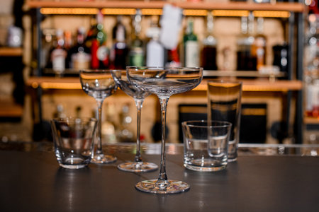 Set of empty crystal clean glasses on dark bar counter.の写真素材