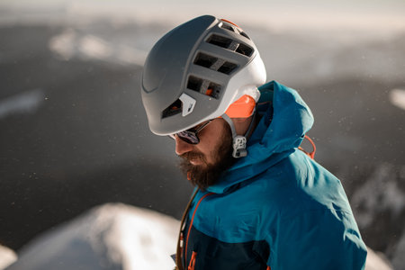 Great side view on head of bearded man in sunglasses and a ski helmet