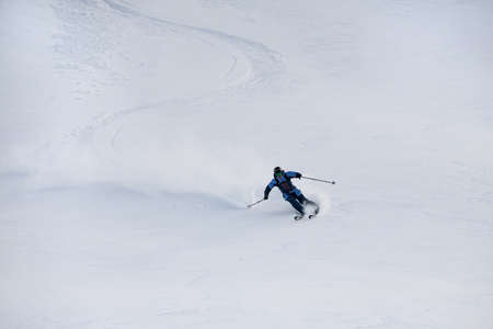 view on snowboarder riding down the untouched powder snow.の写真素材