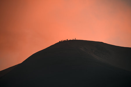 amazing view of snow-capped mountain peak with group of tourists on itの写真素材