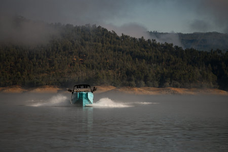 front view of bright blue motorboat quickly floating on the water