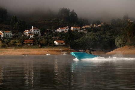 awesome beautiful view of modern bright blue motorboat quickly floating on the waterの写真素材