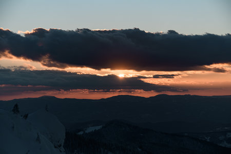 picturesque scene of morning sun and sky and winter mountain landscapeの写真素材