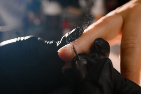Close-up shot of process hardware manicure. Manicurist works with milling cutter and make correction...