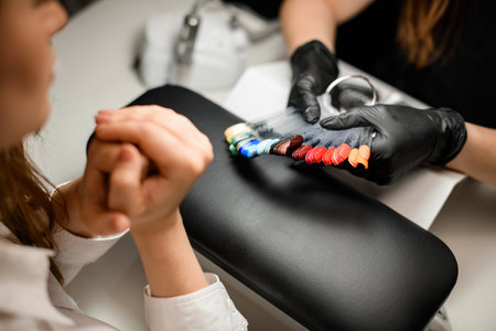 Woman chooses the color of her nails in beauty salon. Beauty and health of nails. Manicure.