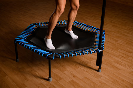 close-up view of beautiful muscular female legs on mini trampolineの写真素材